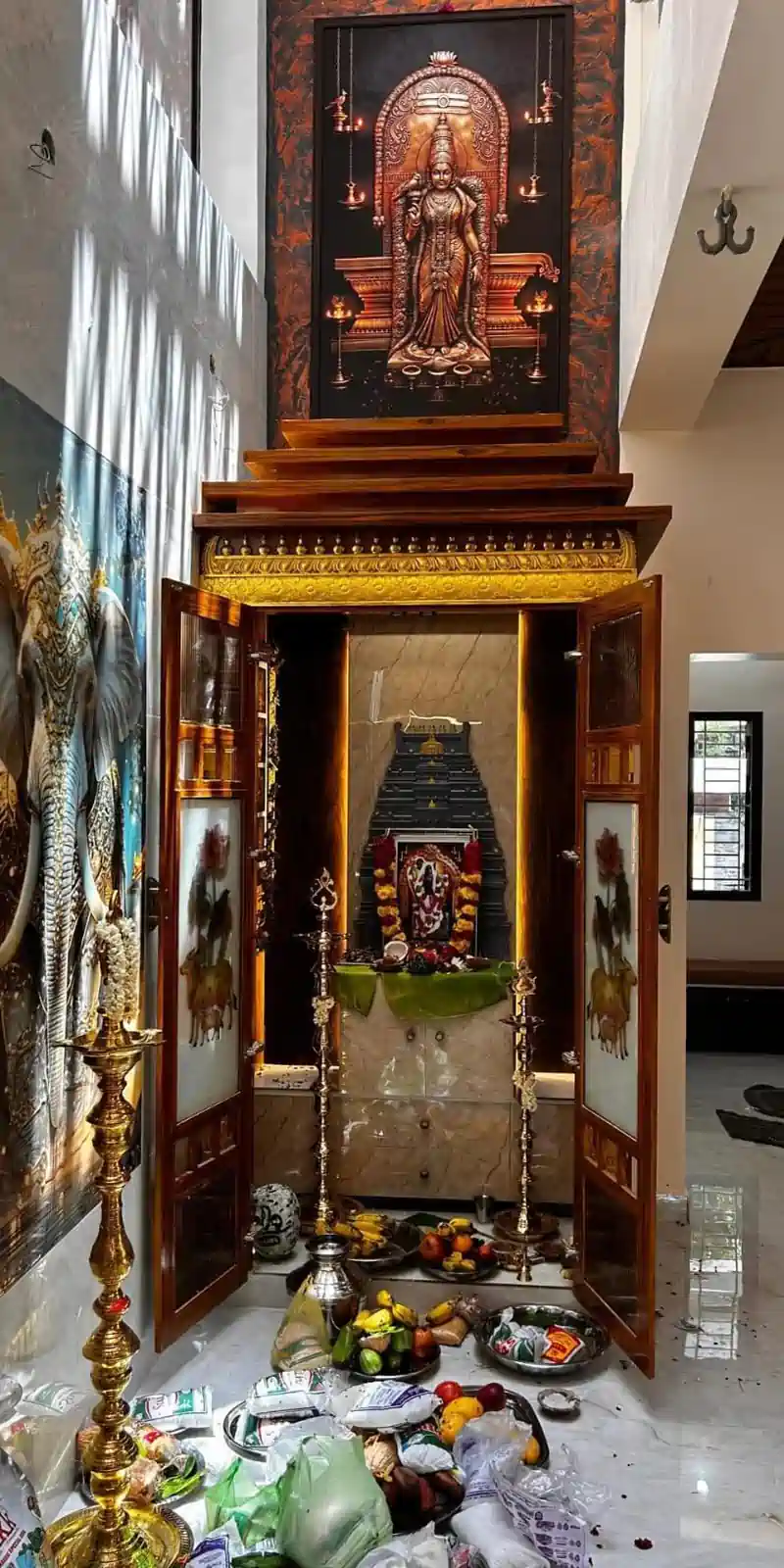 Rawdius Gopuram Customer Installation Dark grey backlit gopuram decor inside a grand wooden pooja cabinet during a home ceremony