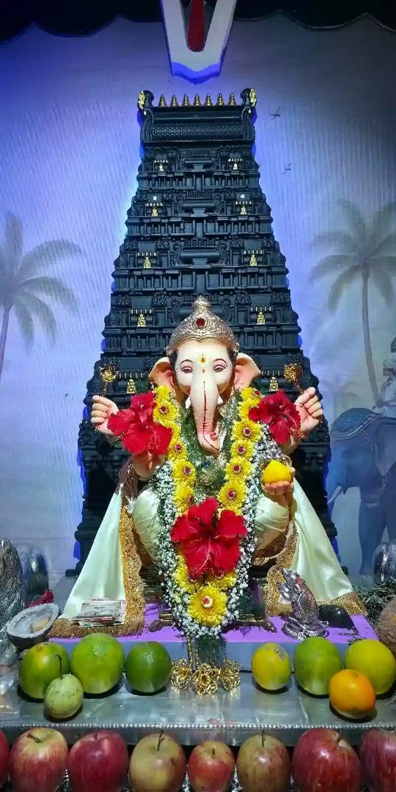 Rawdius Gopuram Customer Installation Decorated Ganesha idol placed before a dark backlit gopuram shrine structure