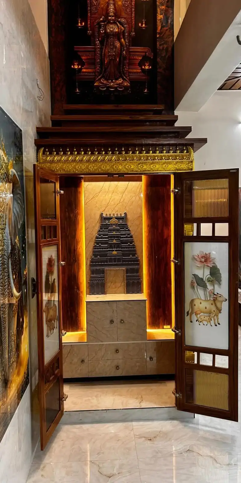 Rawdius Gopuram Customer Installation Grand wooden pooja shrine cabinet with open doors revealing a backlit grey gopuram backdrop