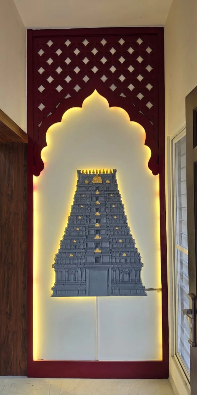 Rawdius Gopuram Customer Installation Grey backlit gopuram art centered inside an ornate arch framed wall section