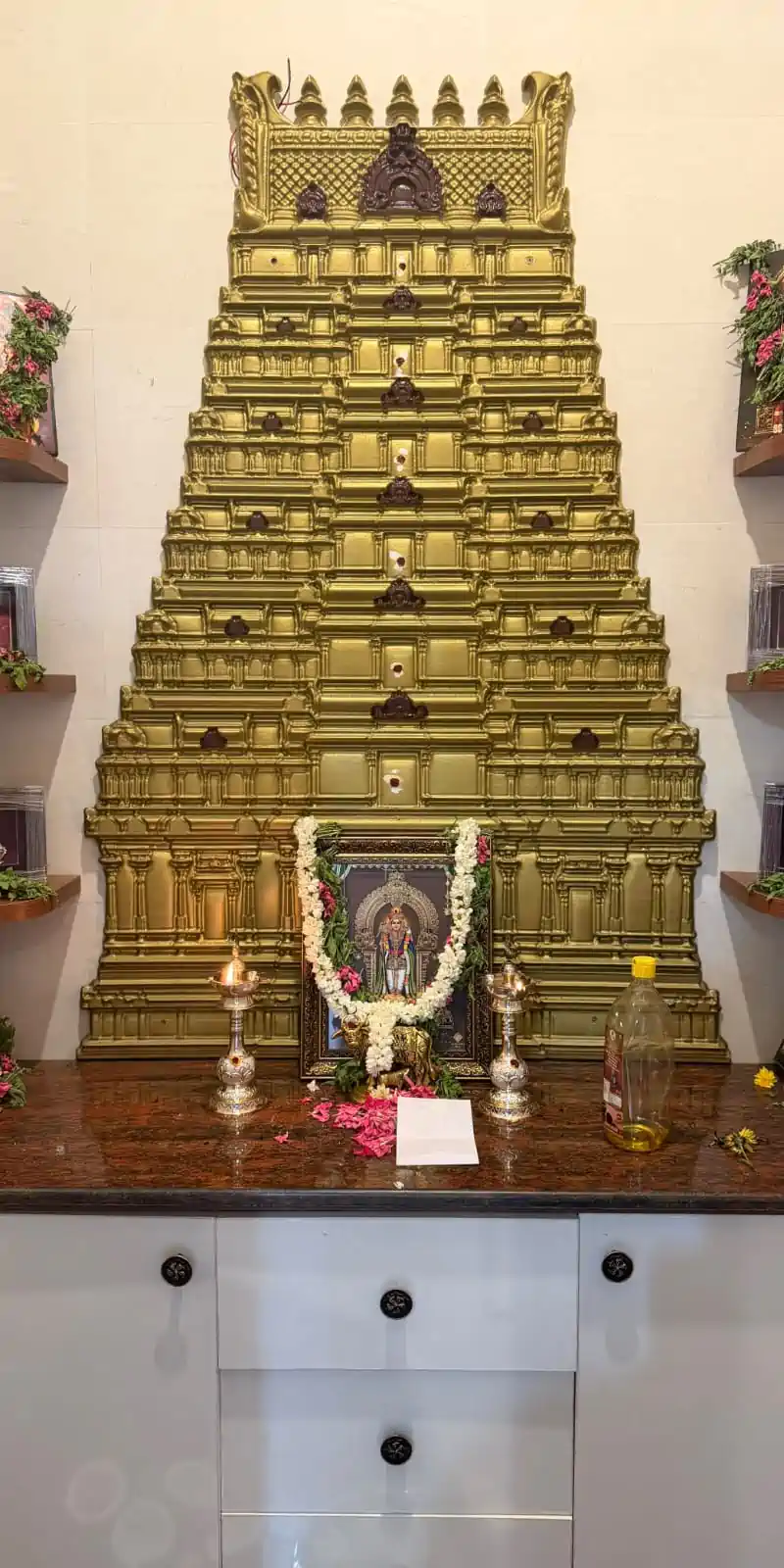 Rawdius Gopuram Customer Installation Ornate gold temple gopuram wall art installed above a pooja altar counter