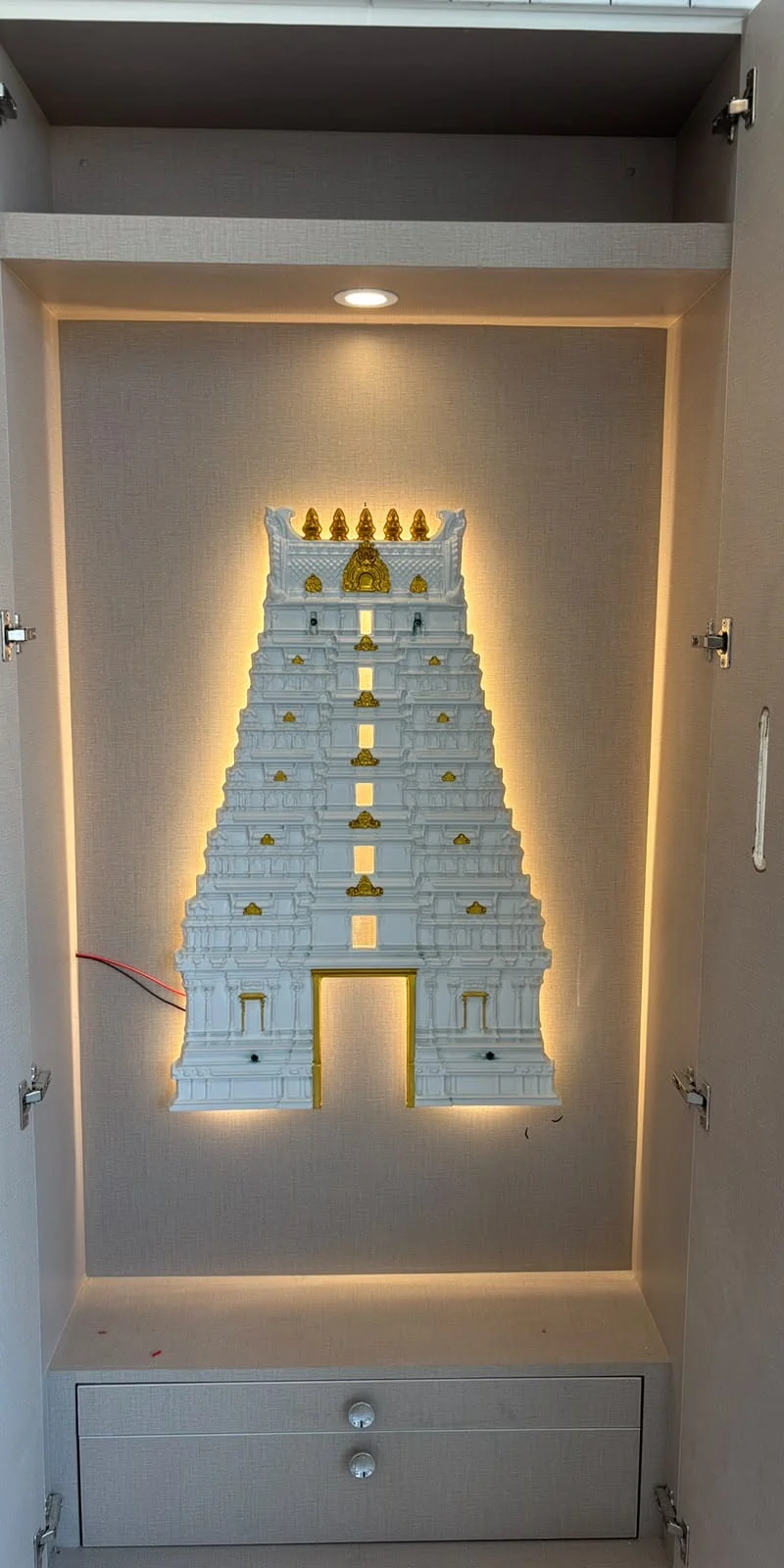 Rawdius Gopuram Customer Installation White backlit gopuram decor installed inside a light wood pooja wardrobe cabinet