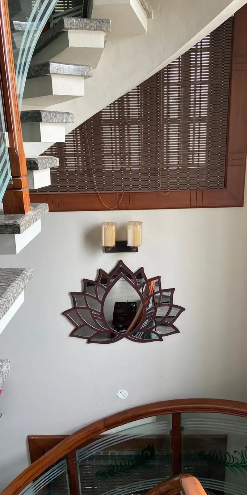 Rawdius Mirror Customer Installation All glass lotus mirror mounted under wall sconces in a stairwell