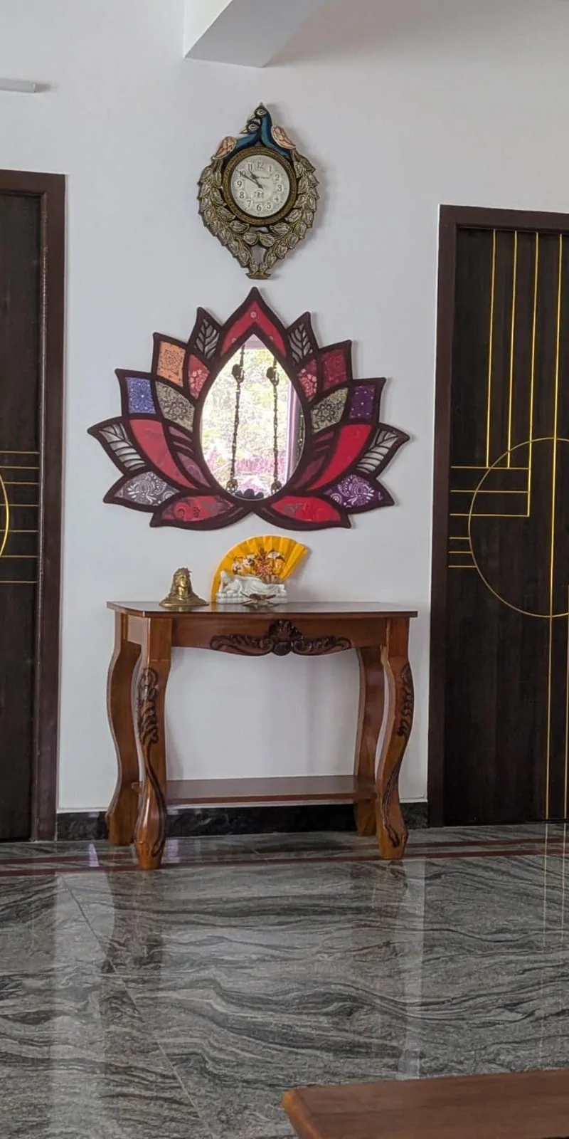 Rawdius Mirror Customer Installation Colorful lotus mirror mounted above a wooden console table