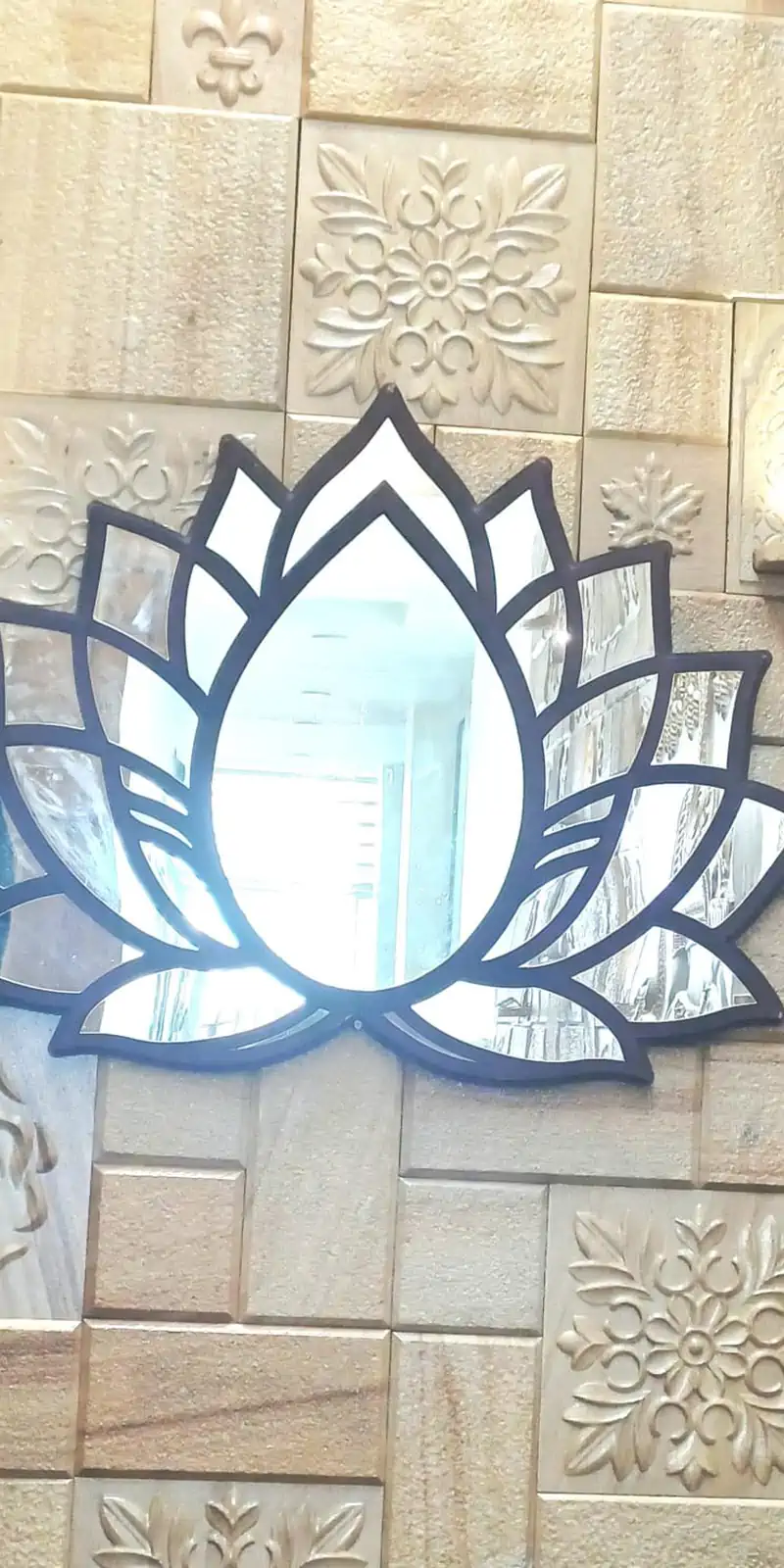 Rawdius Mirror Customer Installation Glass lotus mirror mounted on a textured stone feature wall