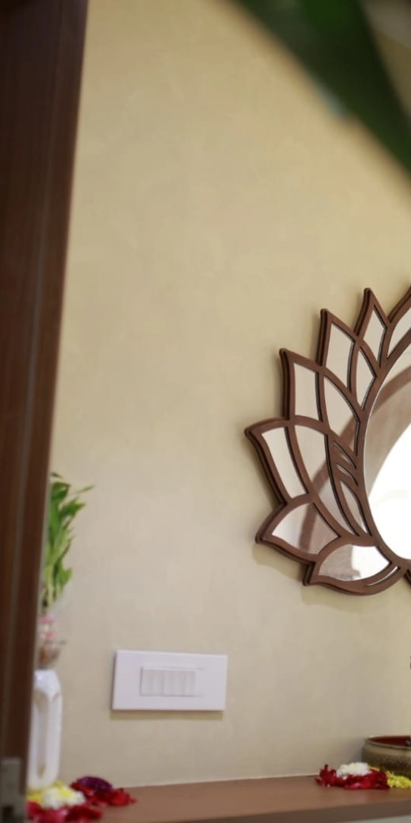Rawdius Mirror Customer Installation Lotus mirror with reflective glass petals mounted on a beige wall