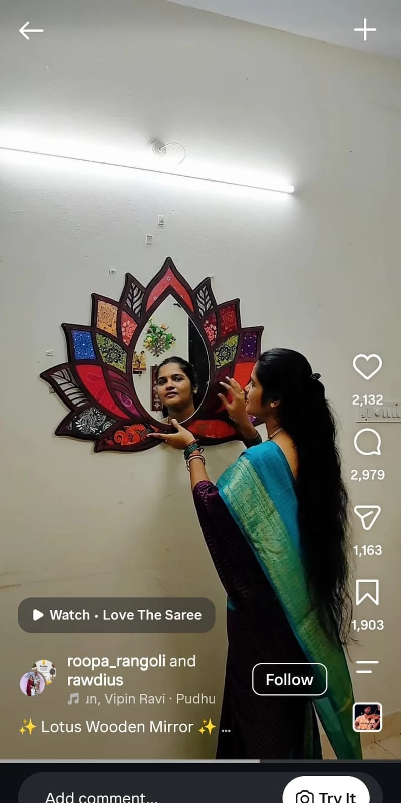 Rawdius Mirror Customer Installation Woman adjusting a colorful patterned lotus mirror on a white wall